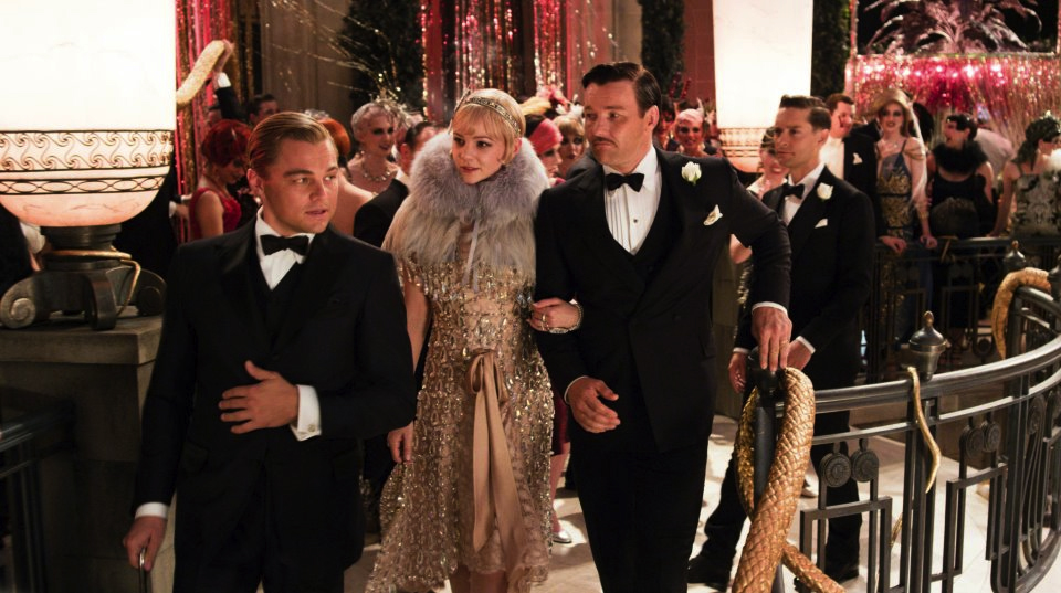 Gatsby showing Daisy and Tom around his party.